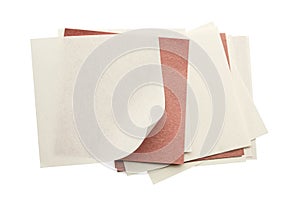 Stack of recycled paper sheets with red paper clip