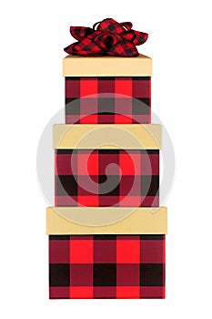 Stack of red and black check Christmas gift boxes isolated on white
