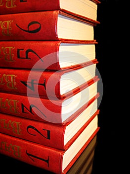 Stack of red books with numbers on black background