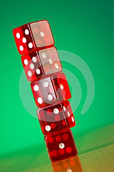 Stack of red casino dice against gradient