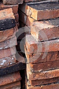 A stack of red not new fire bricks for laying a home stove