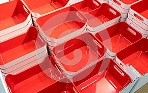 Stack of red plastic trays arrangement for background