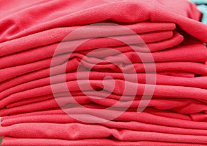 A stack of red T-shirts on the shelves
