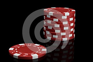 Stack of red and white poker chips on a black background close-up