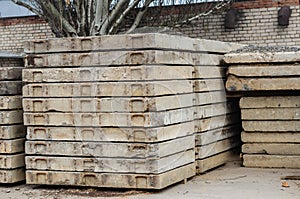 A stack of reinforced concrete slabs outdoors.