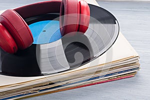 On a stack of retro records, there is a microphone on the surface of the vinyl