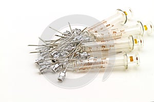 Stack of reuse iron needle No.18 G for drug needle and glass syringe on white background