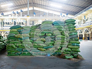 Stack of rice bran bag in the rice milling plant. Agricultural product processing plant. Modern rice miller.