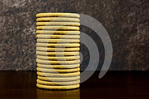 A Stack of Rich Tea Biscuits on a Wooden Shelf