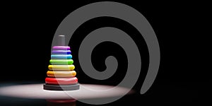 Stack of Rings in Ascending Order Spotlighted on Black Background photo
