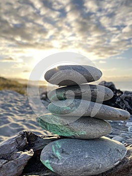 Stack of rocks on the beach with sunset