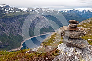 Stack of rocks stones with fjord background in the mountains of