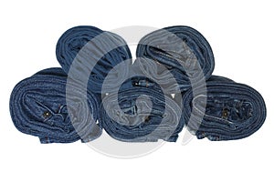 Stack of rolled jeans isolated on white background