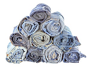 Stack of rolled jeans on white background