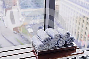 Stack of rolled towels in hotel at gym with city view