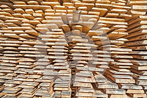 Stack of rough wooden boards in lumberyard