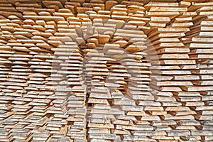 Stack of rough wooden boards in lumberyard