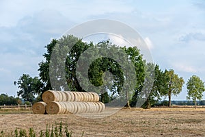 Stack of round bales of straw on a stubble field