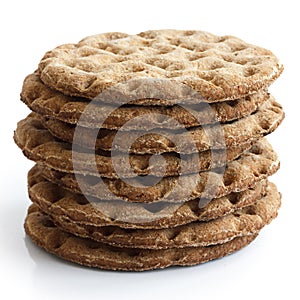 Stack of round rye crispbreads isolated on white.