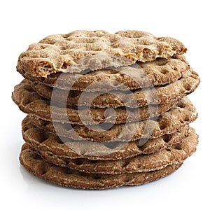 Stack of round rye crispbreads isolated on white. One broken in