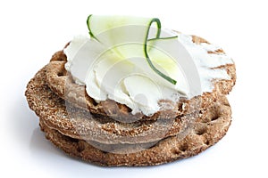 Stack of round rye crispbreads isolated on white. Top one spread