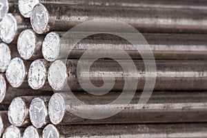 Stack of round steel bar - iron metal rail lines material.