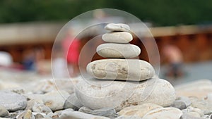 A stack of round stones standing on the shore of a sea. Concept of balance and harmony. Rocks on the coast of the Sea in