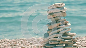 A stack of round stones standing on the shore of a sea. Concept of balance and harmony. Rocks on the coast of the Sea in