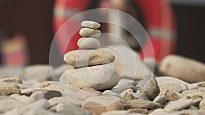 A stack of round stones standing on the shore of a sea. Concept of balance and harmony. Rocks on the coast of the Sea in