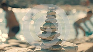 A stack of round stones standing on the shore of a sea. Concept of balance and harmony. Rocks on the coast of the Sea in