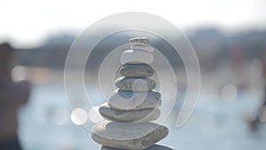 A stack of round stones standing on the shore of a sea. Concept of balance and harmony. Rocks on the coast of the Sea in