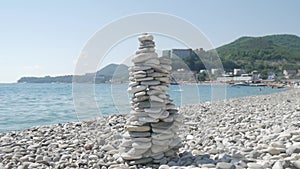 A stack of round stones standing on the shore of a sea. Concept of balance and harmony. Rocks on the coast of the Sea in