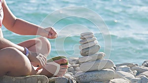 A stack of round stones standing on the shore of a sea. Concept of balance and harmony. Rocks on the coast of the Sea in