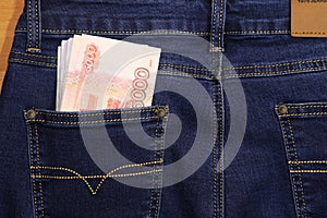 A stack of Russian five-thousandth ruble bills in a pocket of blue jeans. Money in your pocket, cash.