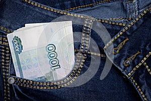 A stack of Russian thousand-ruble bills in a pocket of blue jeans. Money in your pocket, cash.