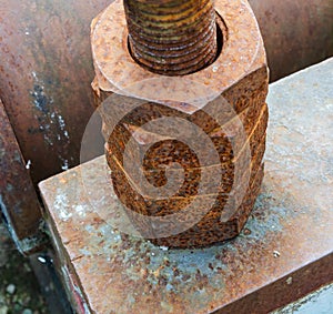 Stack of rusting nuts on a bolt