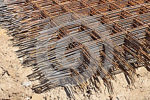 Stack of rusty wire mesh at a construction site. Metal building grate.