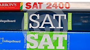 Stack of SAT books contain standardized practice tests for university admissions in USA