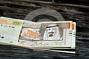 Stack of Saudi Arabia 10 SAR ten Saudi riyals cash money banknote with the photo of king Abdullah Bin AbdulAziz Al Saud