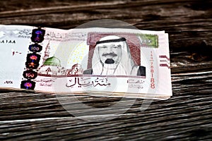 Stack of Saudi Arabia 100 SAR one hundred riyals cash money banknote with the photo of king Abdullah Bin AbdulAziz Al Saud