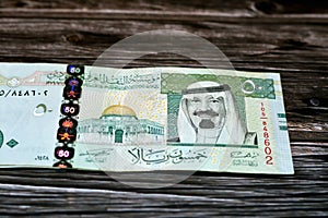 Stack of Saudi Arabia 50 SAR fifty Saudi riyals cash money banknote with the photo of king Abdullah Bin AbdulAziz Al Saud