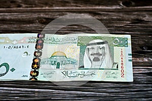 Stack of Saudi Arabia 50 SAR fifty Saudi riyals cash money banknote with the photo of king Abdullah Bin AbdulAziz Al Saud
