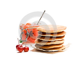 Stack of scotch pancakes with wild apples jam isolated on white