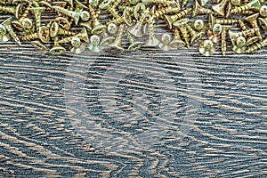 Stack of screws on wooden board
