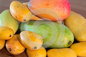 Stack of several varieties of Mangos of different size and colors