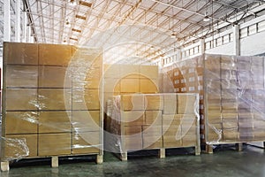Stack of shipments boxes on wooden pallets. Interior of warehouse storage