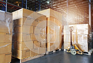 Stack of shipments boxes on wooden pallets. Interior of warehouse storage.