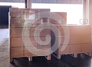 Stack of shipments boxes on wooden pallets. Interior of warehouse storage.