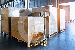 Stack of shipments boxes on wooden pallets. Interior of warehouse storage.