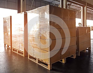 Stack of shipments boxes on wooden pallets. Interior of warehouse storage.